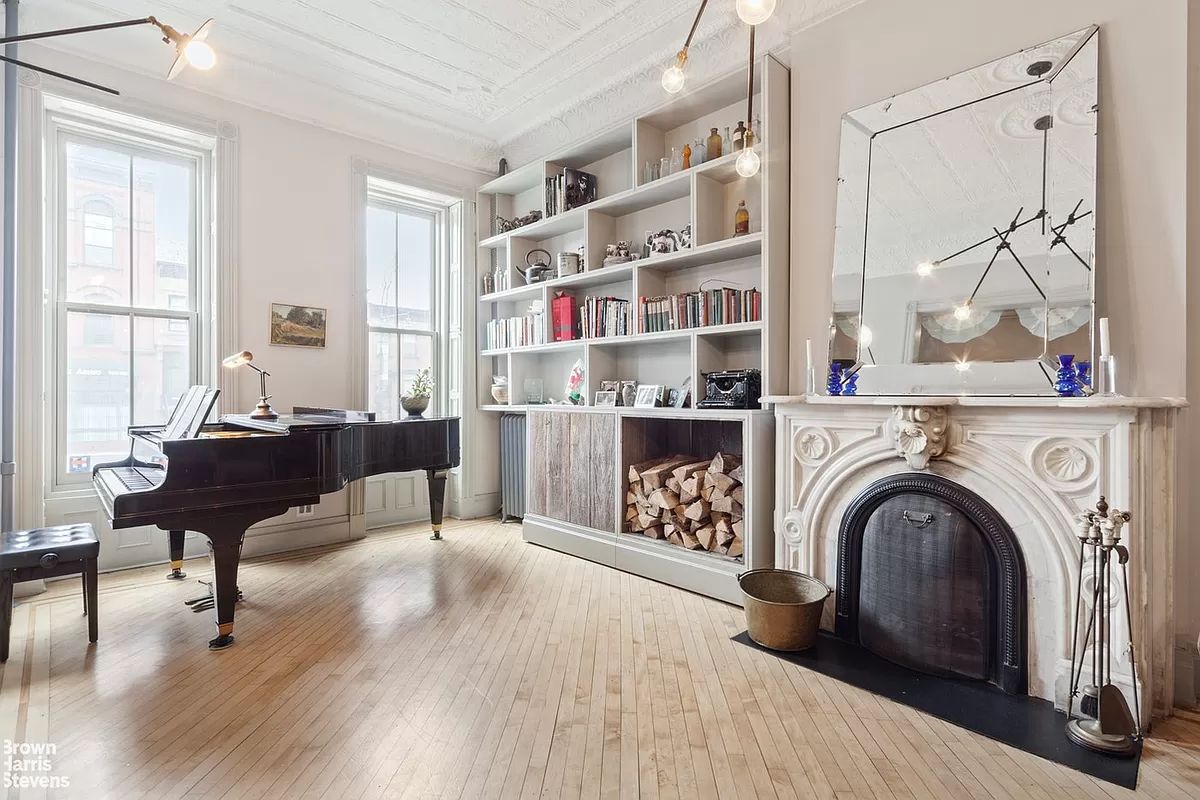 a living room with furniture and a book shelf