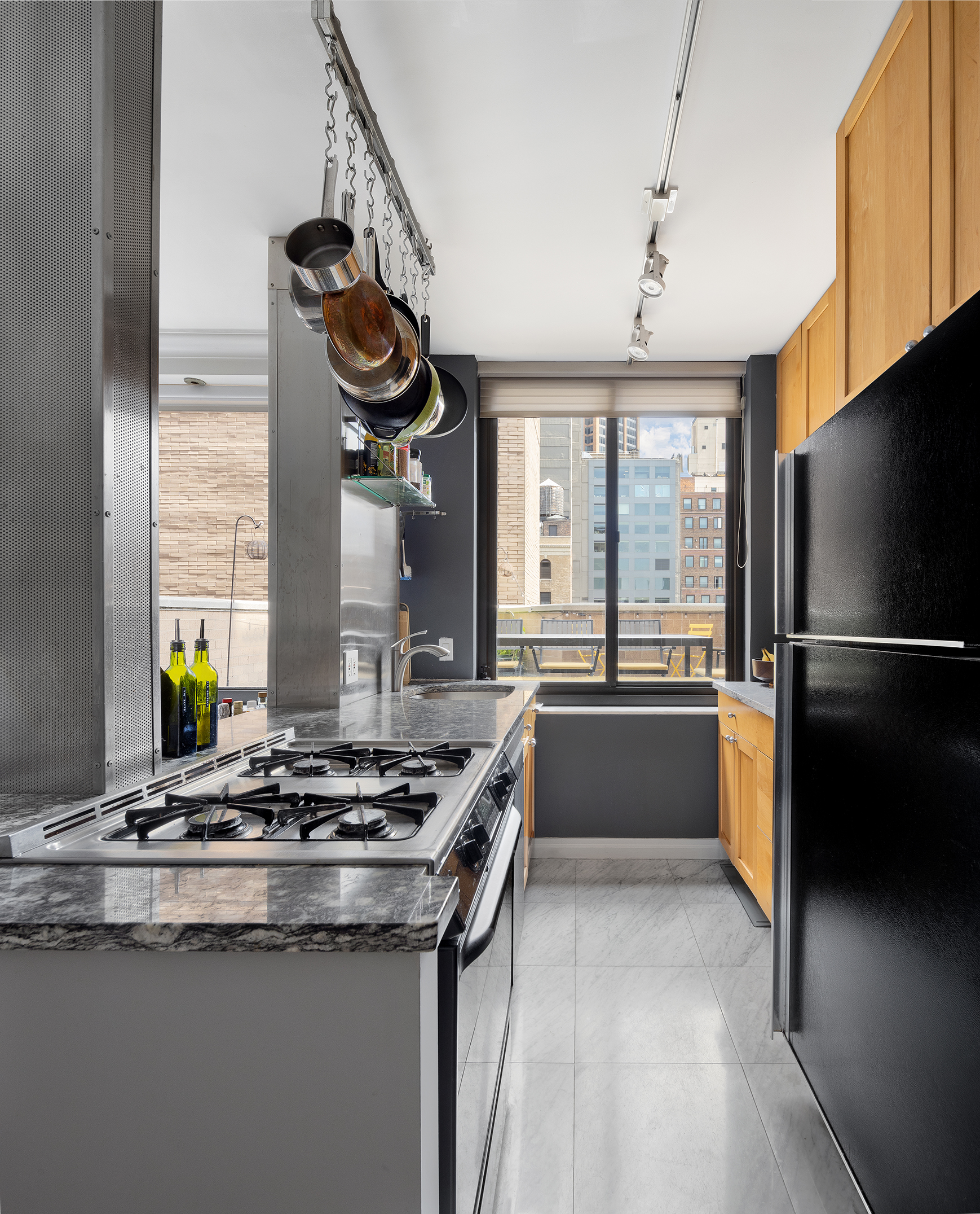 111 East 30th Street, Unit 16C Manhattan, NY 10016 - Photo 5 of 13 a kitchen with a refrigerator and a sink