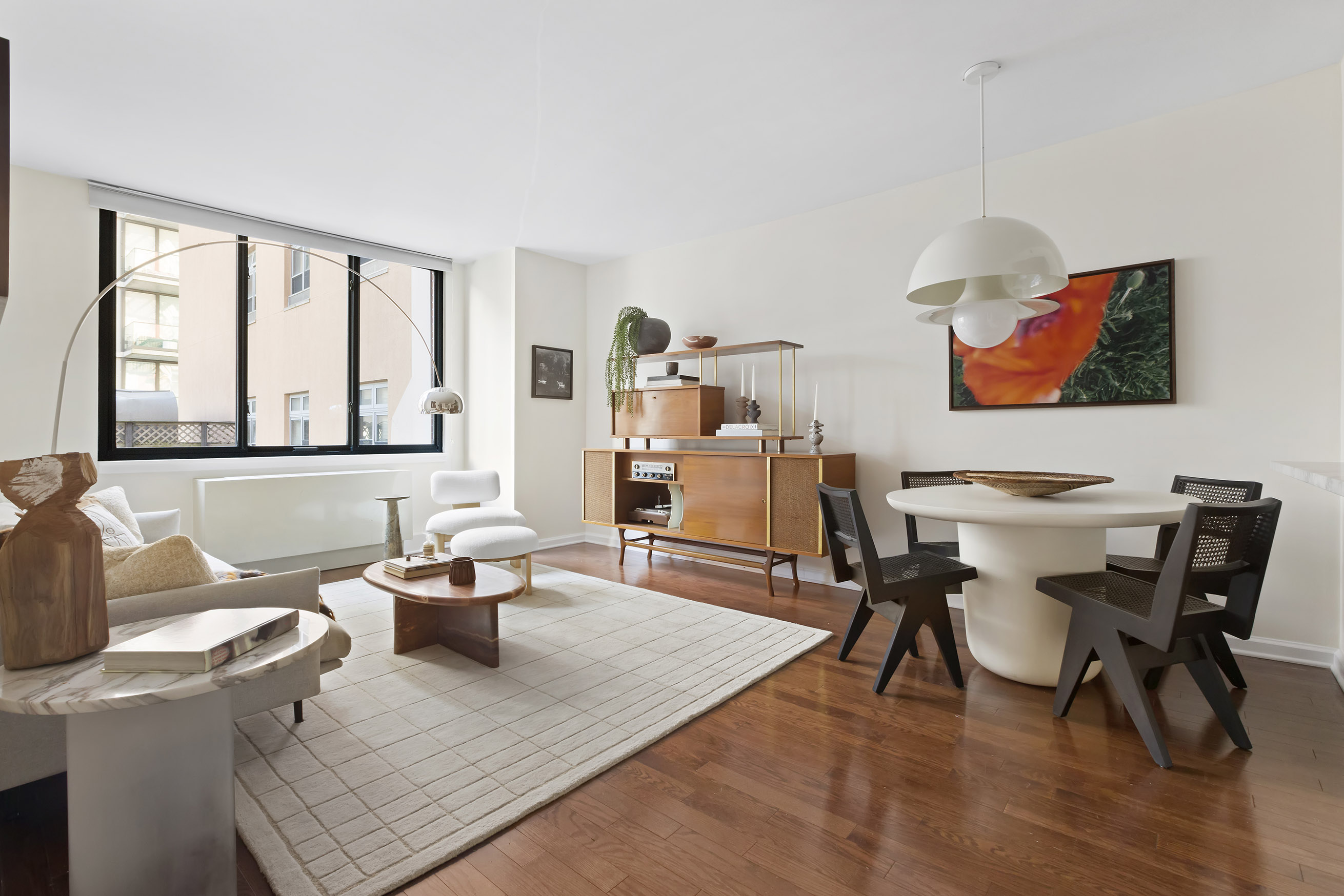 199 Bowery, Unit 3D Manhattan, NY 10002 - Photo 2 of 11 a living room with furniture and a large window