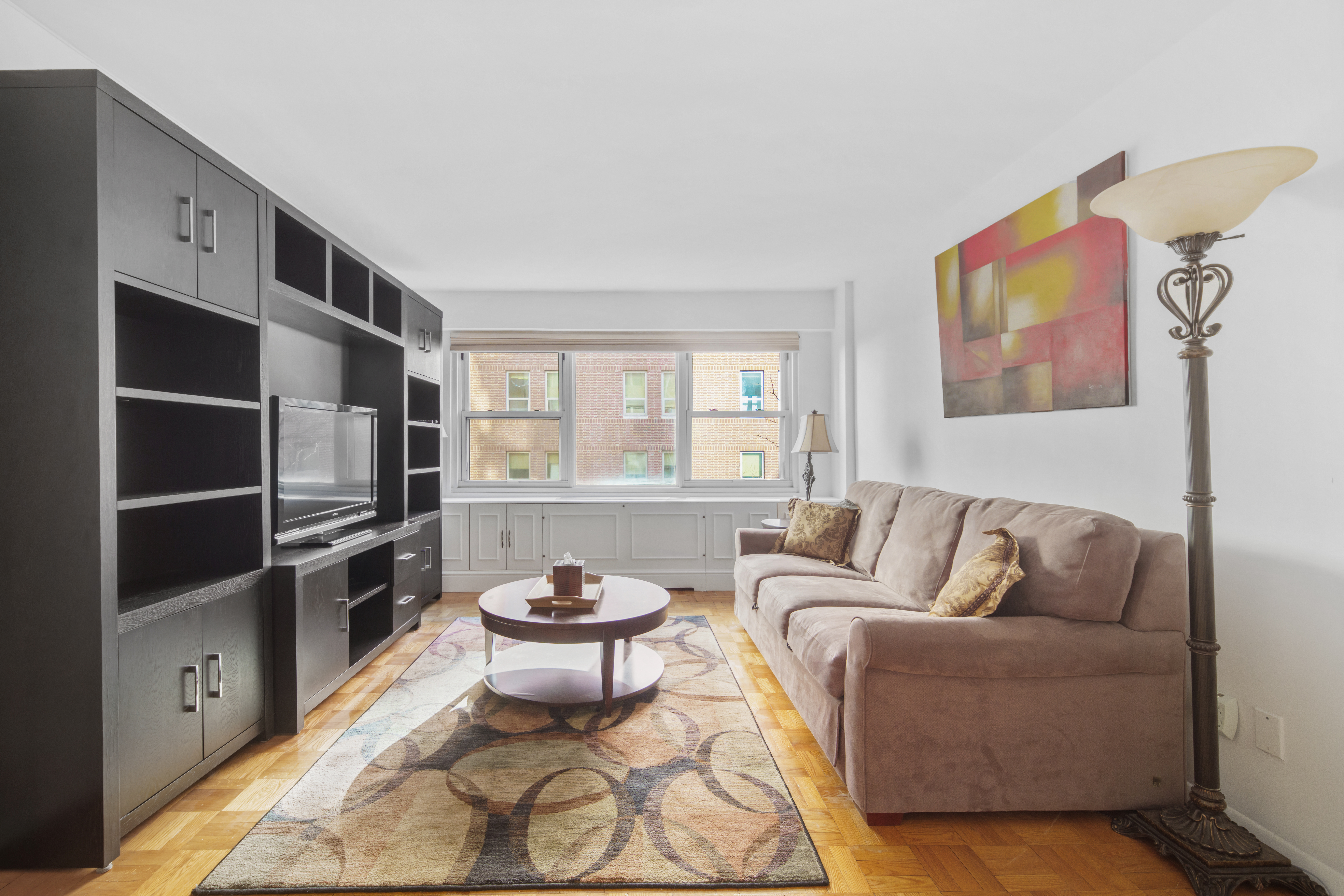 210 East 63rd Street, Unit 5B Manhattan, NY 10065 - Photo 2 of 6 a living room with furniture and a window