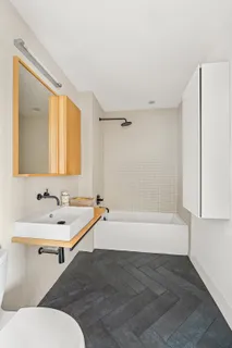 a bathroom with a bathtub and a sink