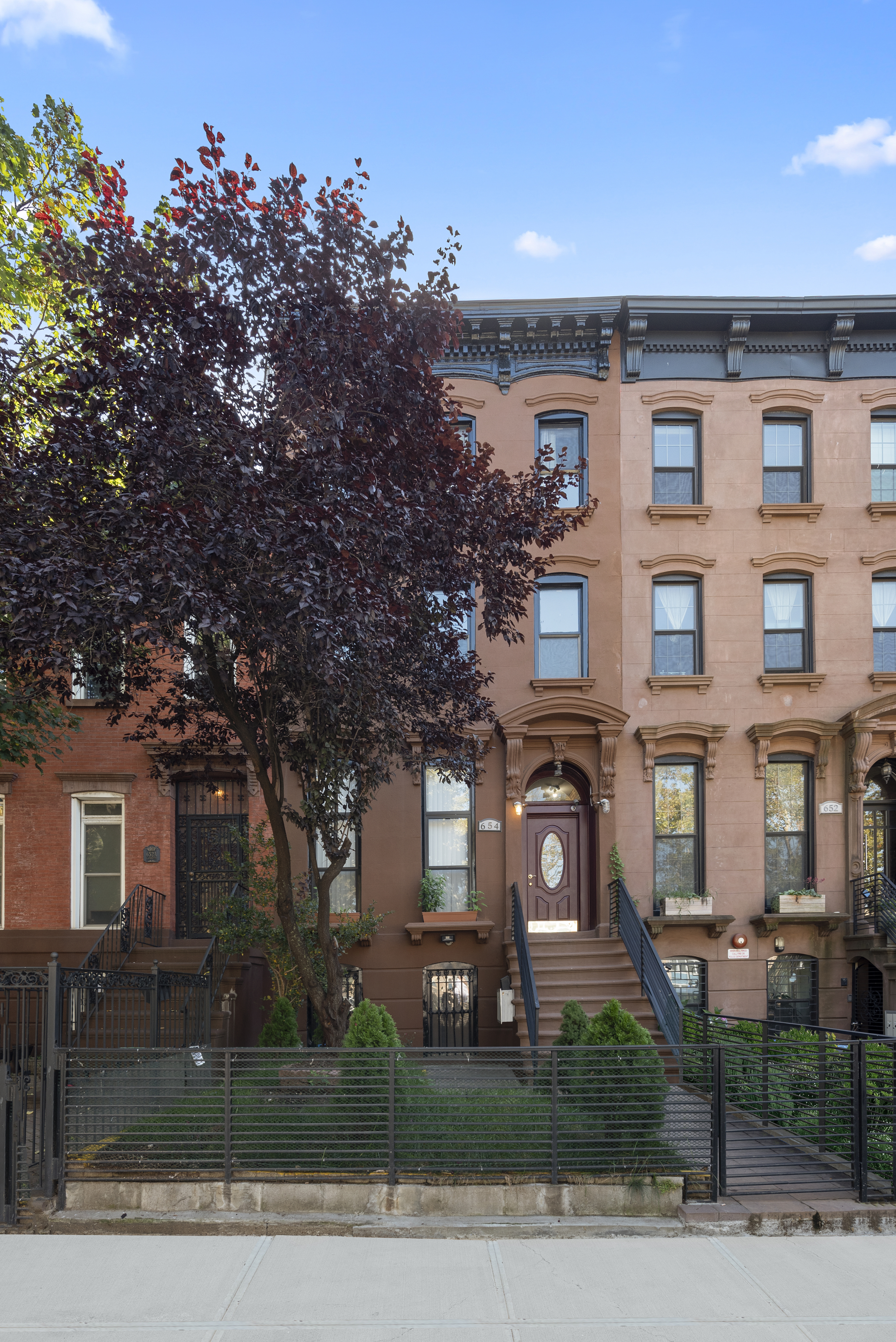 654 Lafayette Avenue, Unit GARDENA Brooklyn, NY 11216 - Photo 13 of 14 a front view of a residential apartment building with a yard