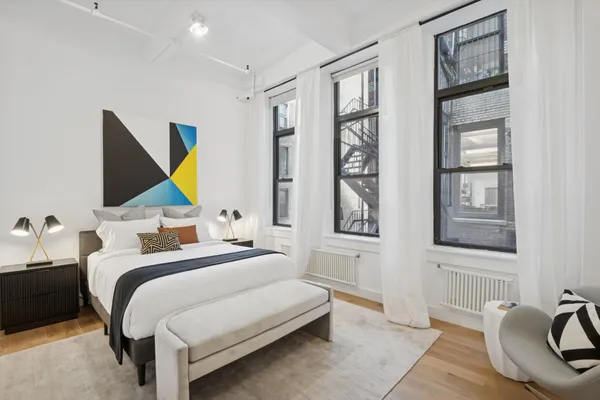 a bedroom with a bed and a couch