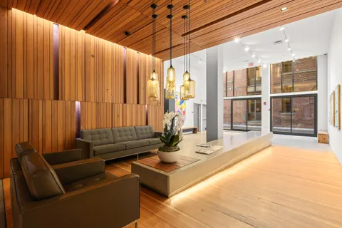 a living room with furniture and large windows