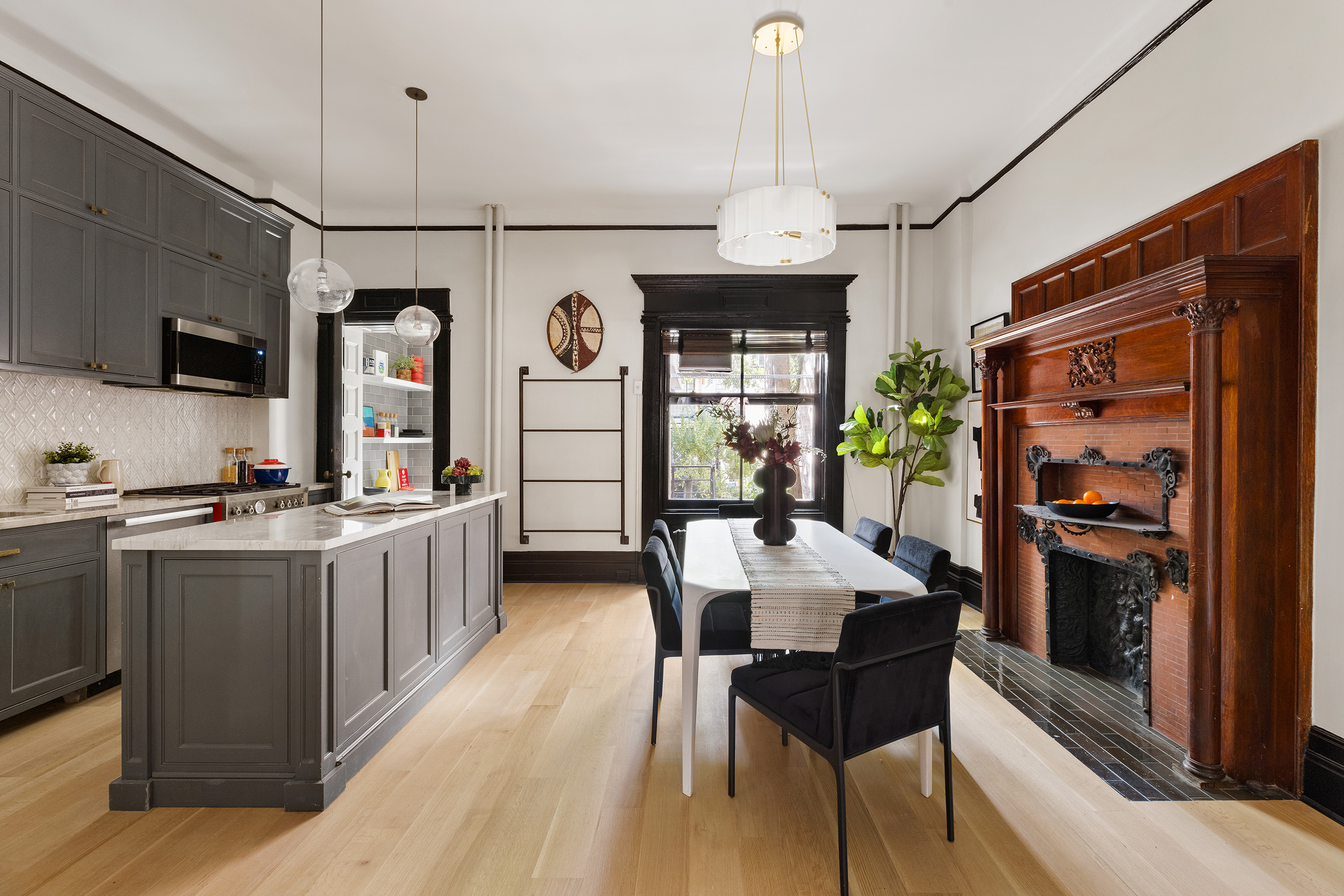 614 West 146th Street, Unit 4FAM Manhattan, NY 10031 - Photo 7 of 18 a open kitchen with stainless steel appliances granite countertop a stove a refrigerator a oven a sink with a countertop and chairs