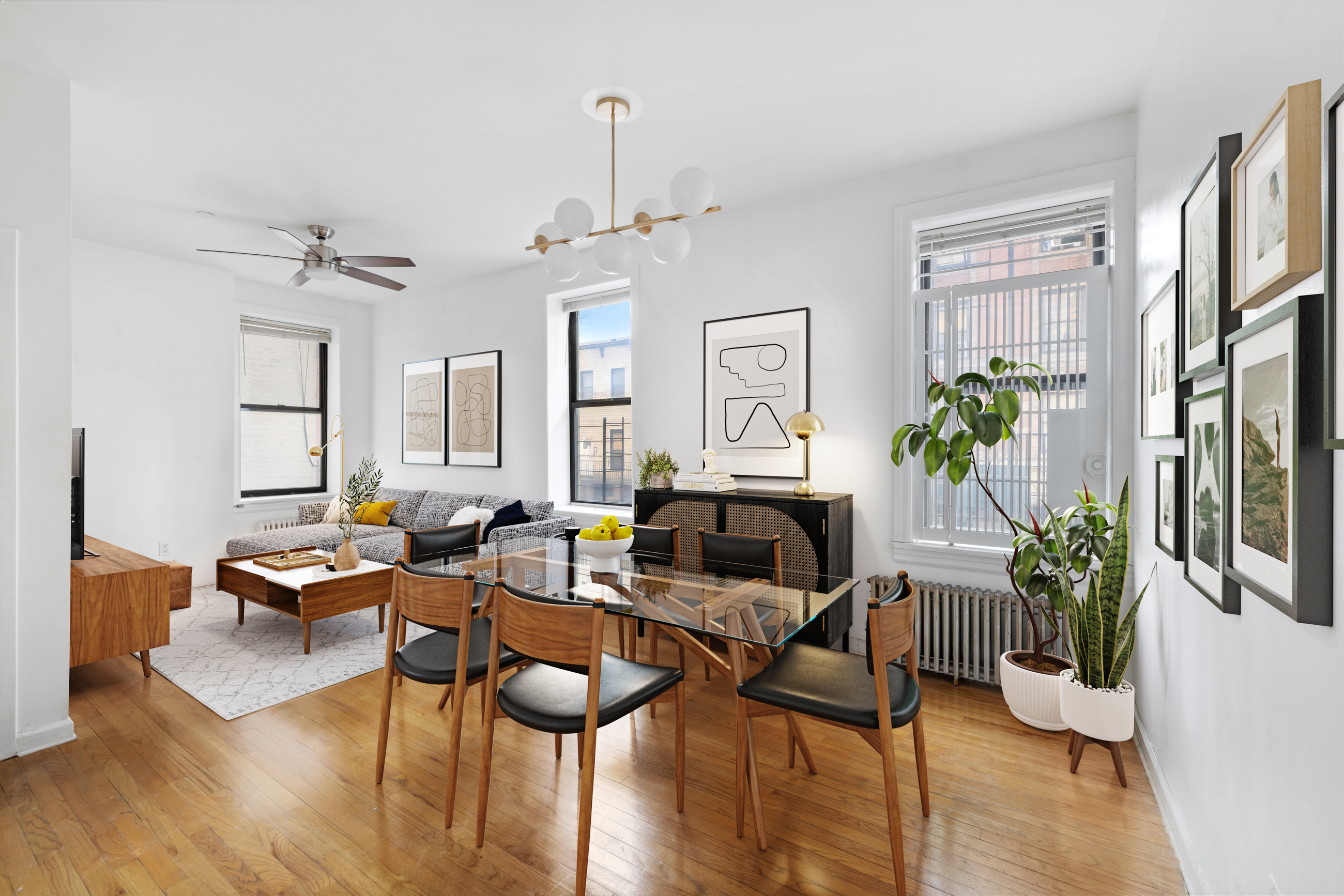 469 West 166th Street, Unit 2C Manhattan, NY 10032 - Photo 2 of 13 a living room with furniture potted plant and a window
