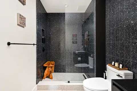 a bathroom with a toilet sink and shower