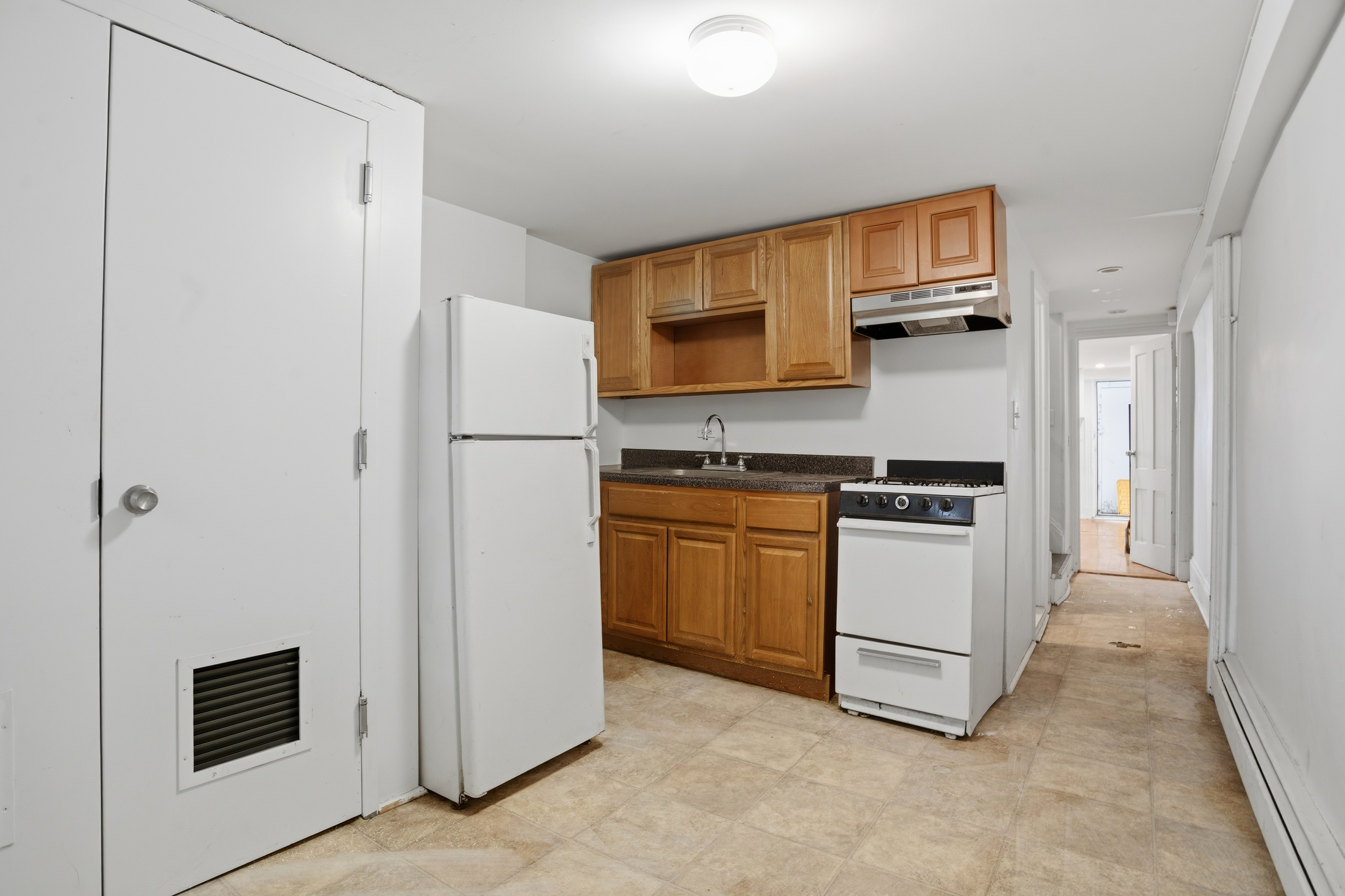 417 A 18th Street Brooklyn, NY 11215 - Photo 11 of 16 a kitchen with stainless steel appliances a refrigerator and a stove top oven
