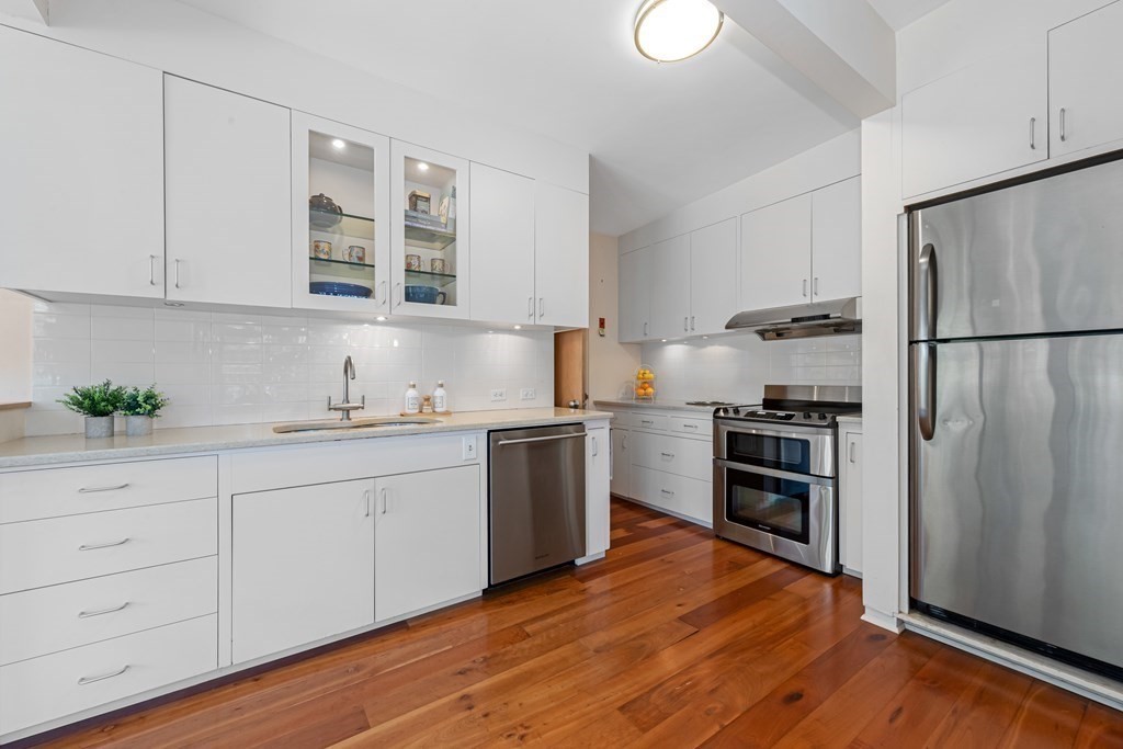 5 Field Road Lexington, MA 02421 - Photo 6 of 17 a kitchen with granite countertop stainless steel appliances a refrigerator a sink and a stove