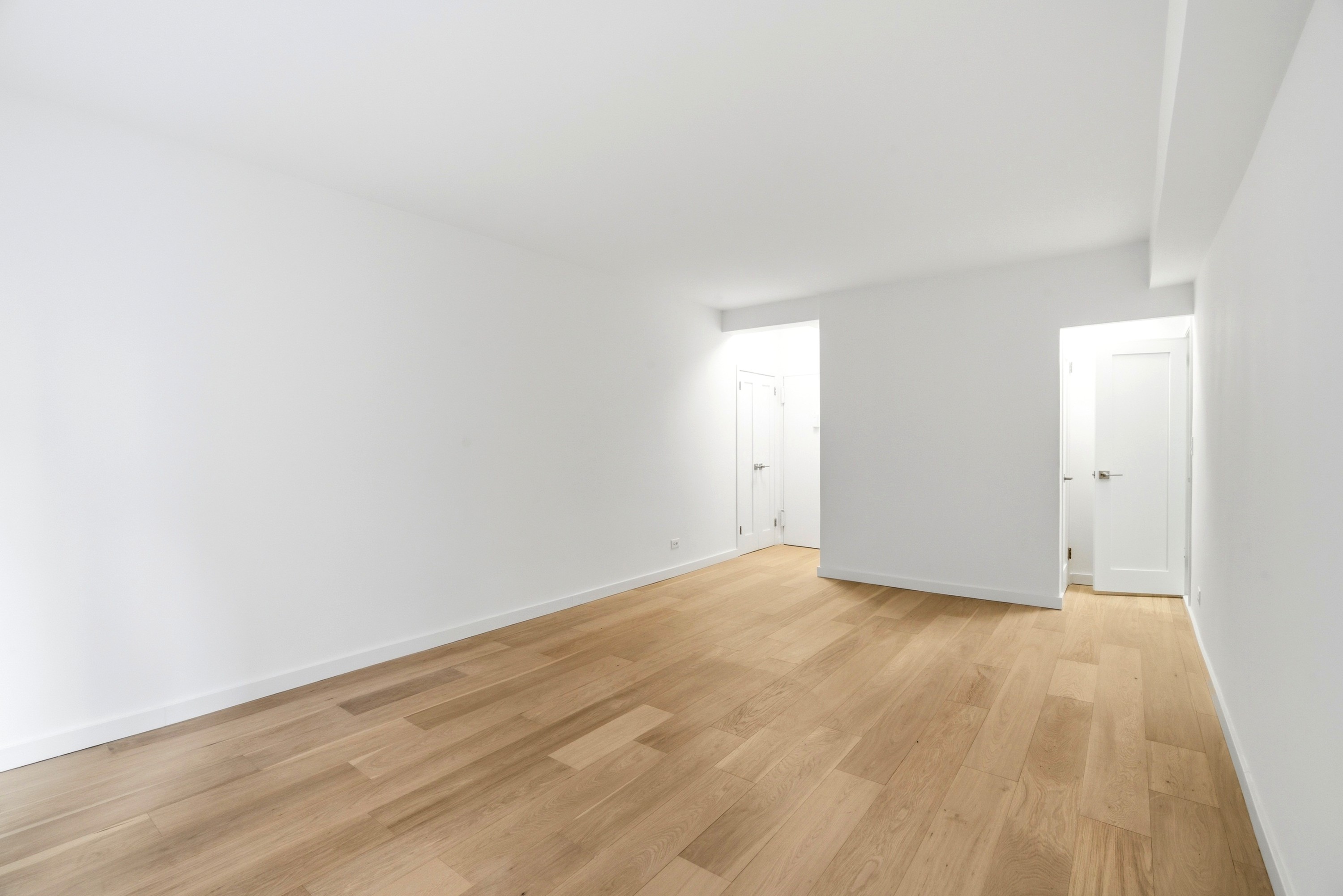 240 East 46th Street, Unit 8J Manhattan, NY 10017 - Photo 4 of 11 a view of an empty room and wooden floor