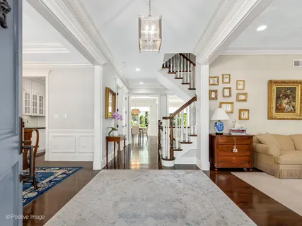 a view of entryway with wooden floor and front door