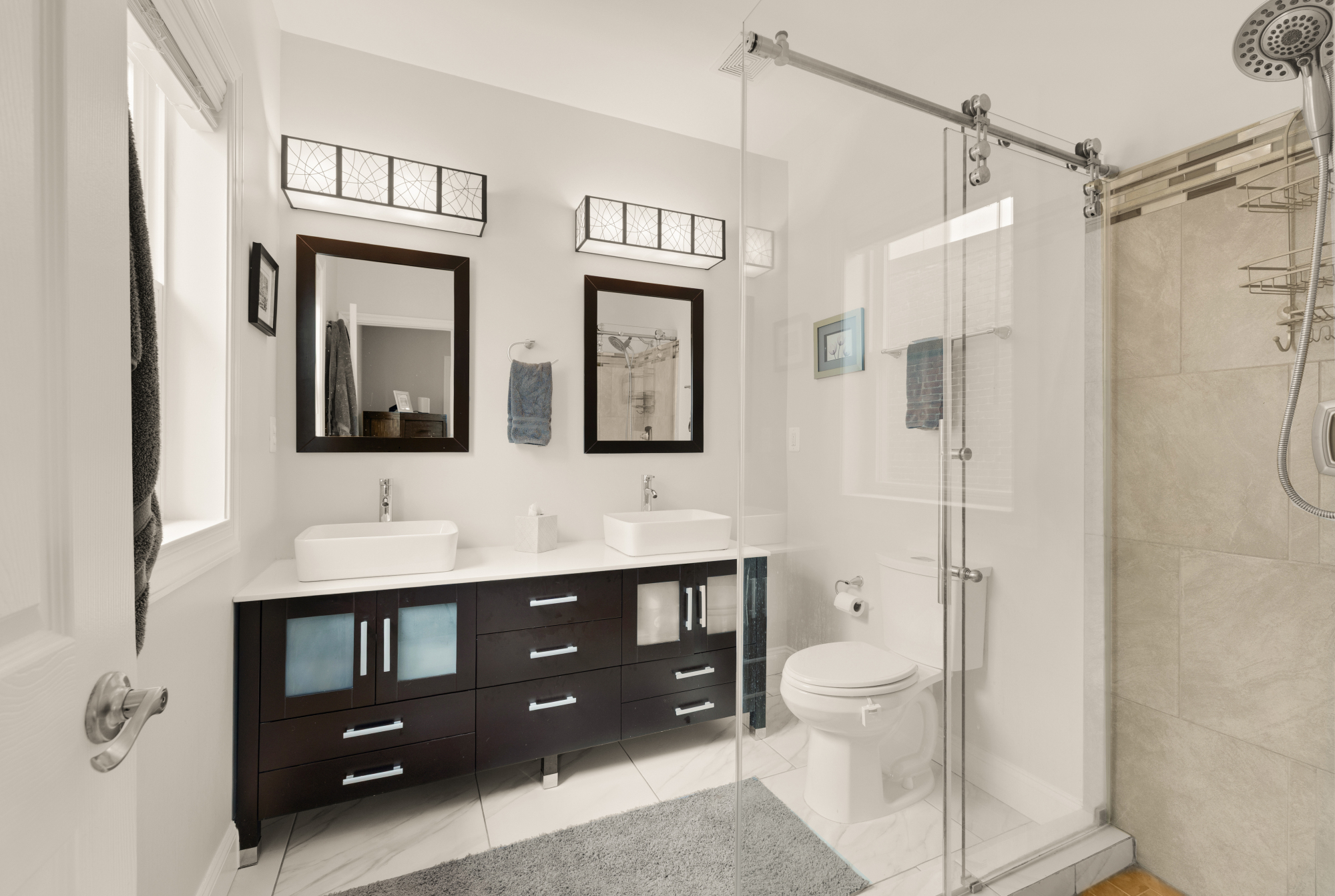 233 S Street Northeast, Unit 4 Washington, DC 20002 - Photo 26 of 37 a bathroom with a double vanity sink toilet mirror and shower