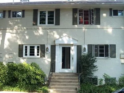 a front view of a house with plants