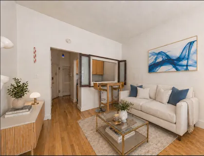 a living room with furniture a rug and a painting on the wall