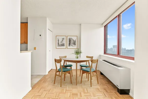 a dining room with furniture and window