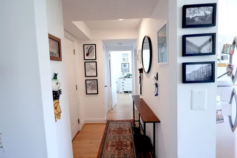 a picture of a hallway with paintings on the wall