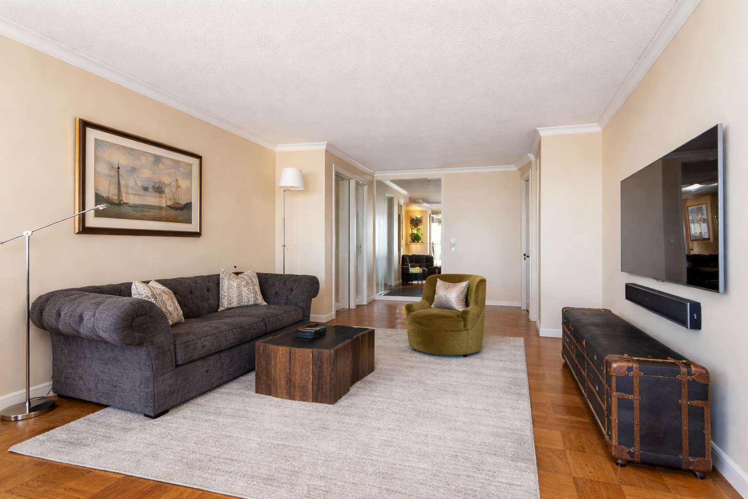50 East 89th Street, Unit 31C Manhattan, NY 10128 - Photo 4 of 18 a living room with furniture and a flat screen tv