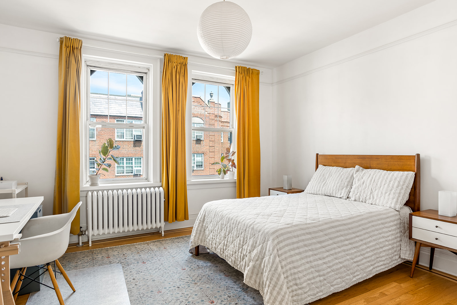 35-14 77th Street, Unit 52 Queens, NY 11372 - Photo 4 of 11 a bedroom with a bed and a window