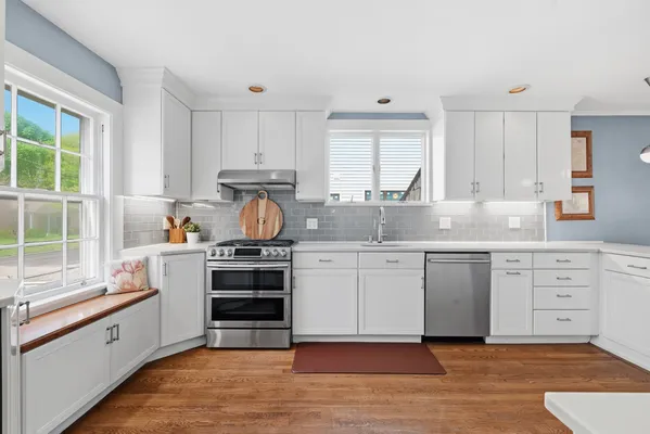 a kitchen with stainless steel appliances granite countertop a stove and cabinets