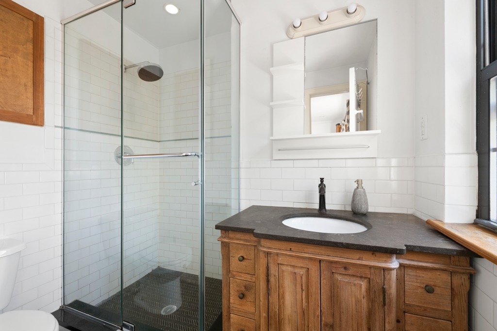 82 Visitation Place, Unit 2 Brooklyn, NY 11231 - Photo 8 of 12 a bathroom with a sink a mirror and shower