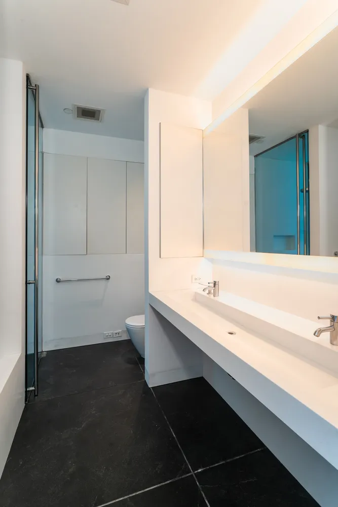 a bathroom with a tub sink and shower