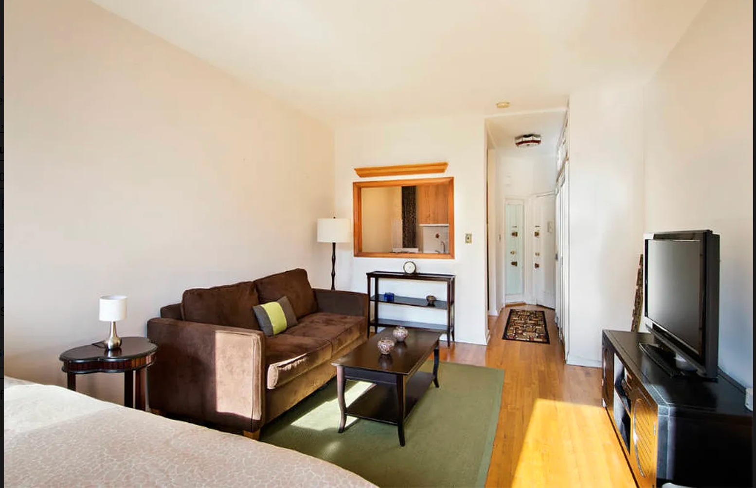 416 East 83rd Street, Unit 4B Manhattan, NY 10028 - Photo 2 of 6 a living room with furniture and a flat screen tv