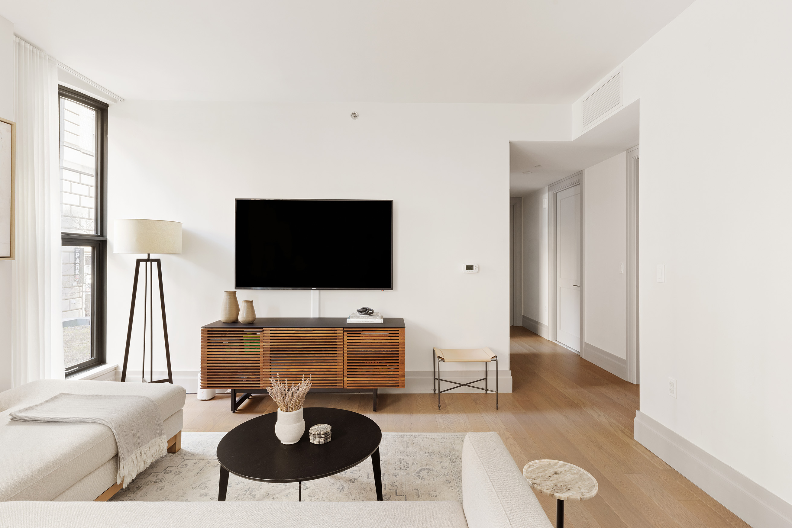 76 Schermerhorn Street, Unit 2C Brooklyn, NY 11201 - Photo 3 of 16 a living room with furniture and a flat screen tv