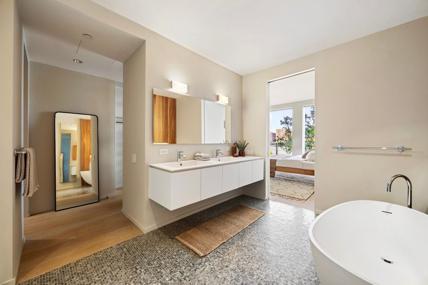 a bathroom with a double vanity sink mirror and bathtub