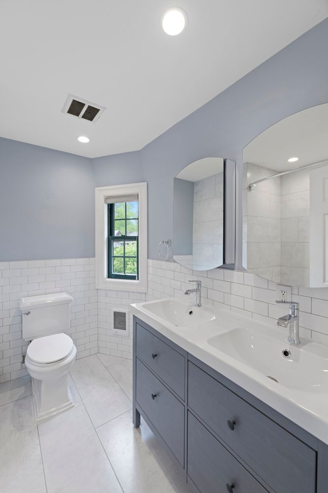 a bathroom with a sink a toilet and a mirror