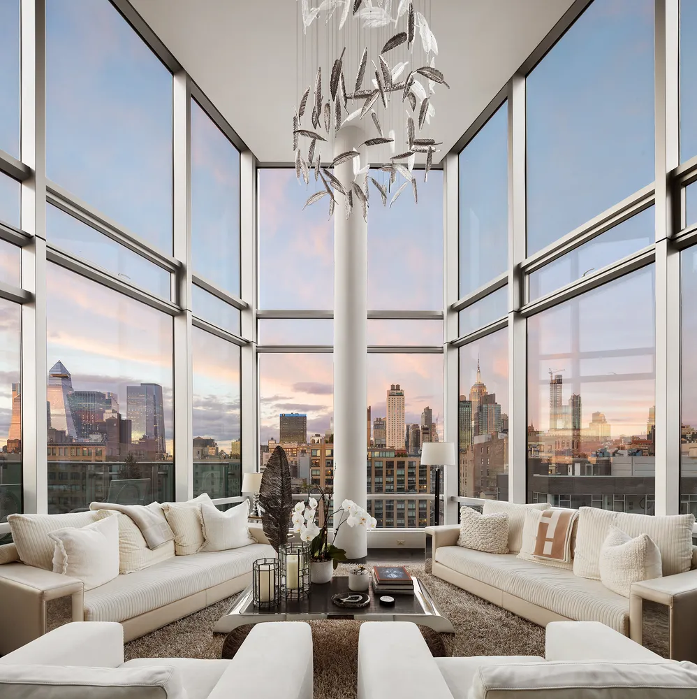 a living room with furniture city view and large windows