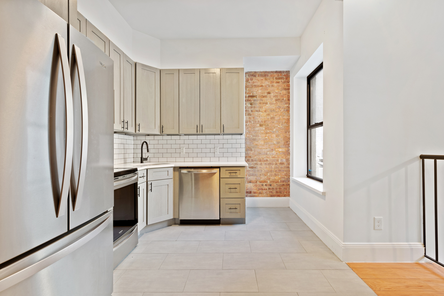 443 Jefferson Avenue, Unit 1L Brooklyn, NY 11221 - Photo 2 of 12 a kitchen with white cabinets and a refrigerator