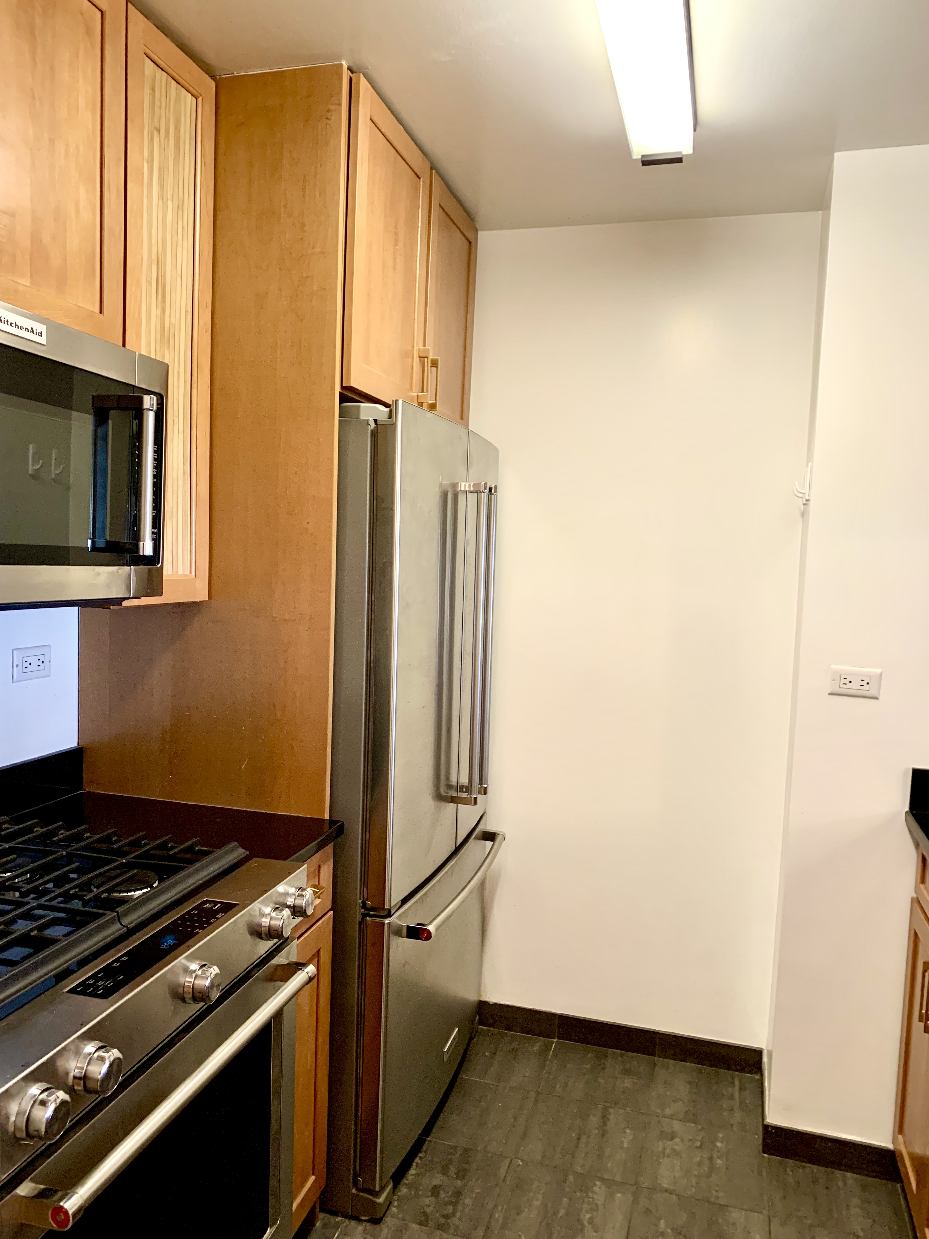 200 Rector Place, Unit 2C Manhattan, NY 10280 - Photo 7 of 19 a kitchen with a refrigerator and a stove
