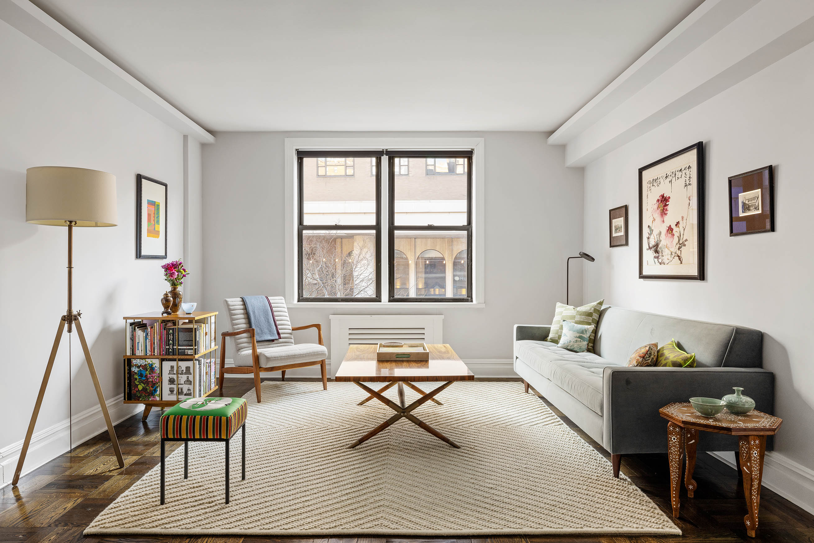 60 East 9th Street, Unit 211 Manhattan, NY 10003 - Photo 2 of 7 a living room with furniture rug and window