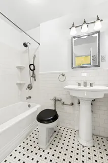a bathroom with a sink toilet a mirror a vanity and bathtub