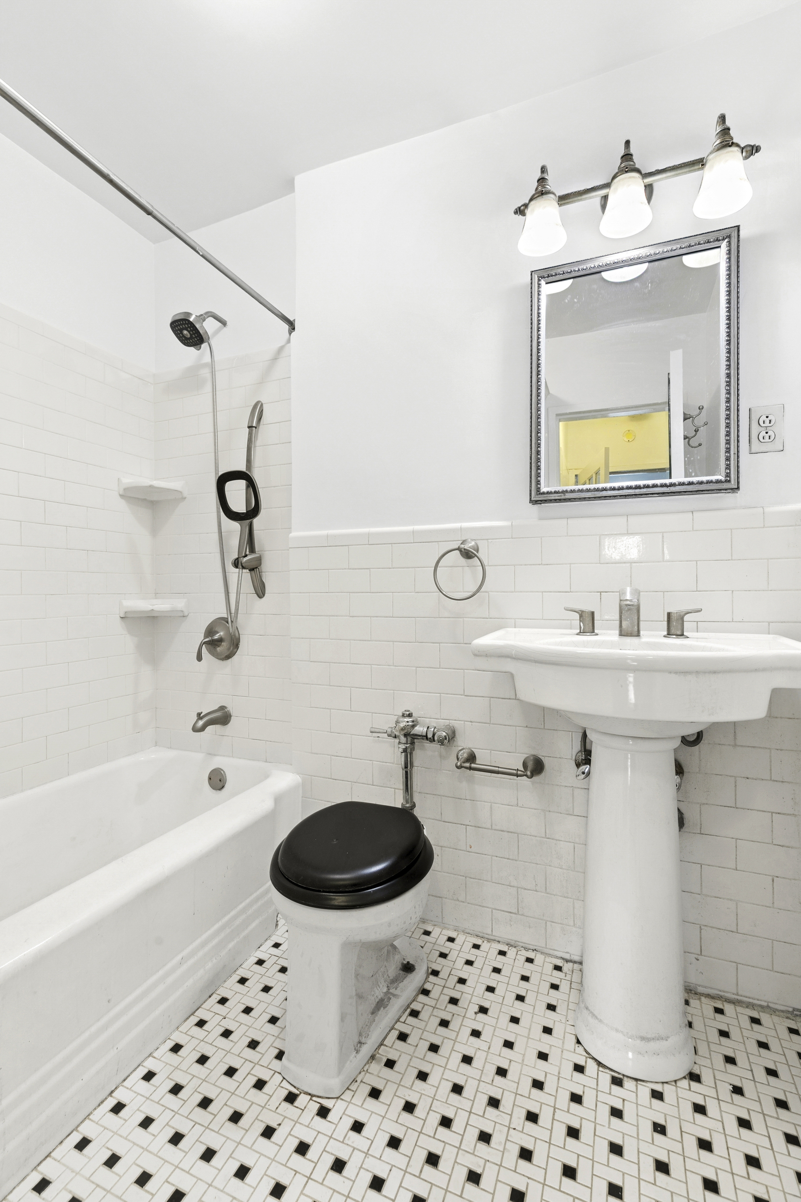 411 East 57th Street, Unit 4B Manhattan, NY 10022 - Photo 5 of 7 a bathroom with a sink toilet a mirror a vanity and bathtub