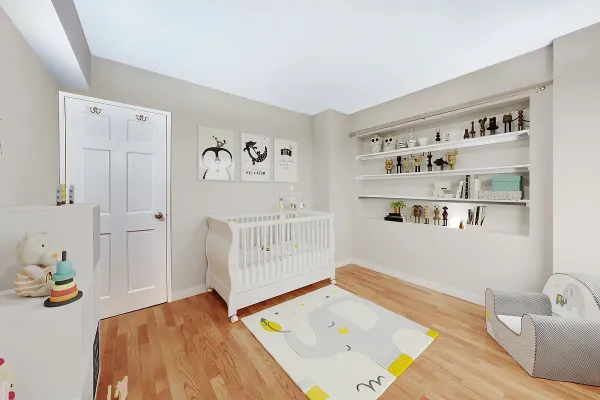 a bedroom with a bed and a wooden floor