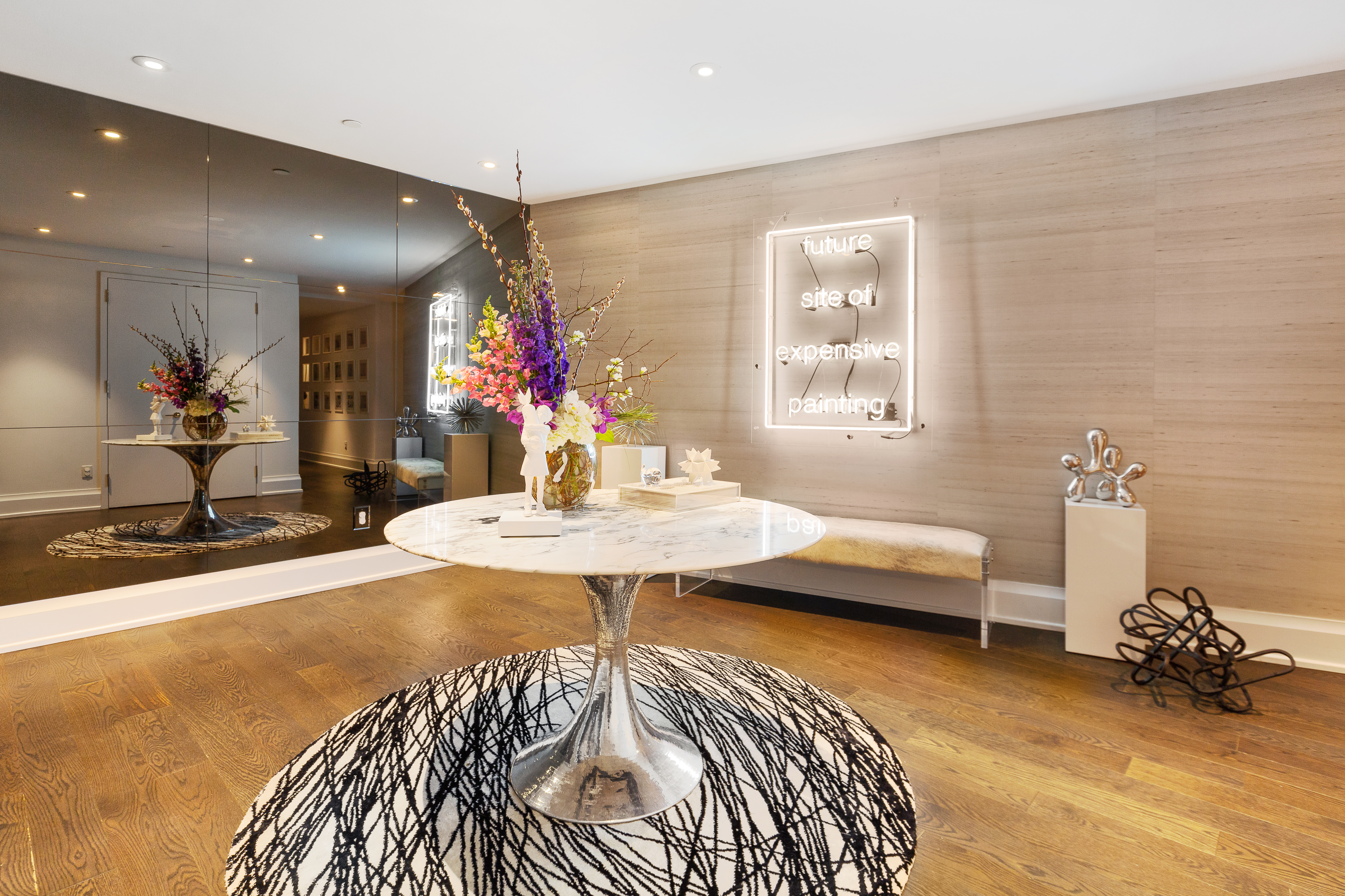 50 Riverside Boulevard, Unit 14L Manhattan, NY 10069 - Photo 4 of 22 a living room with furniture and a chandelier