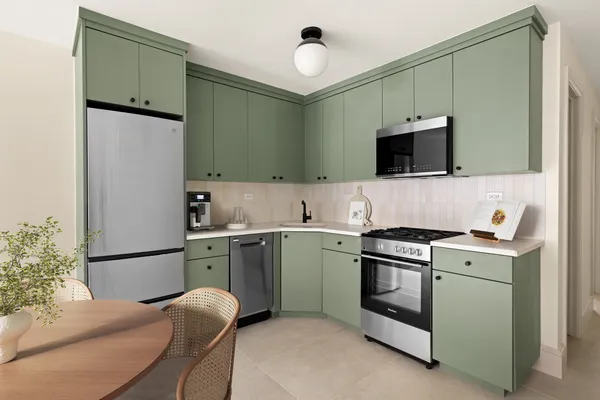a kitchen with stainless steel appliances white cabinets and a stove top oven