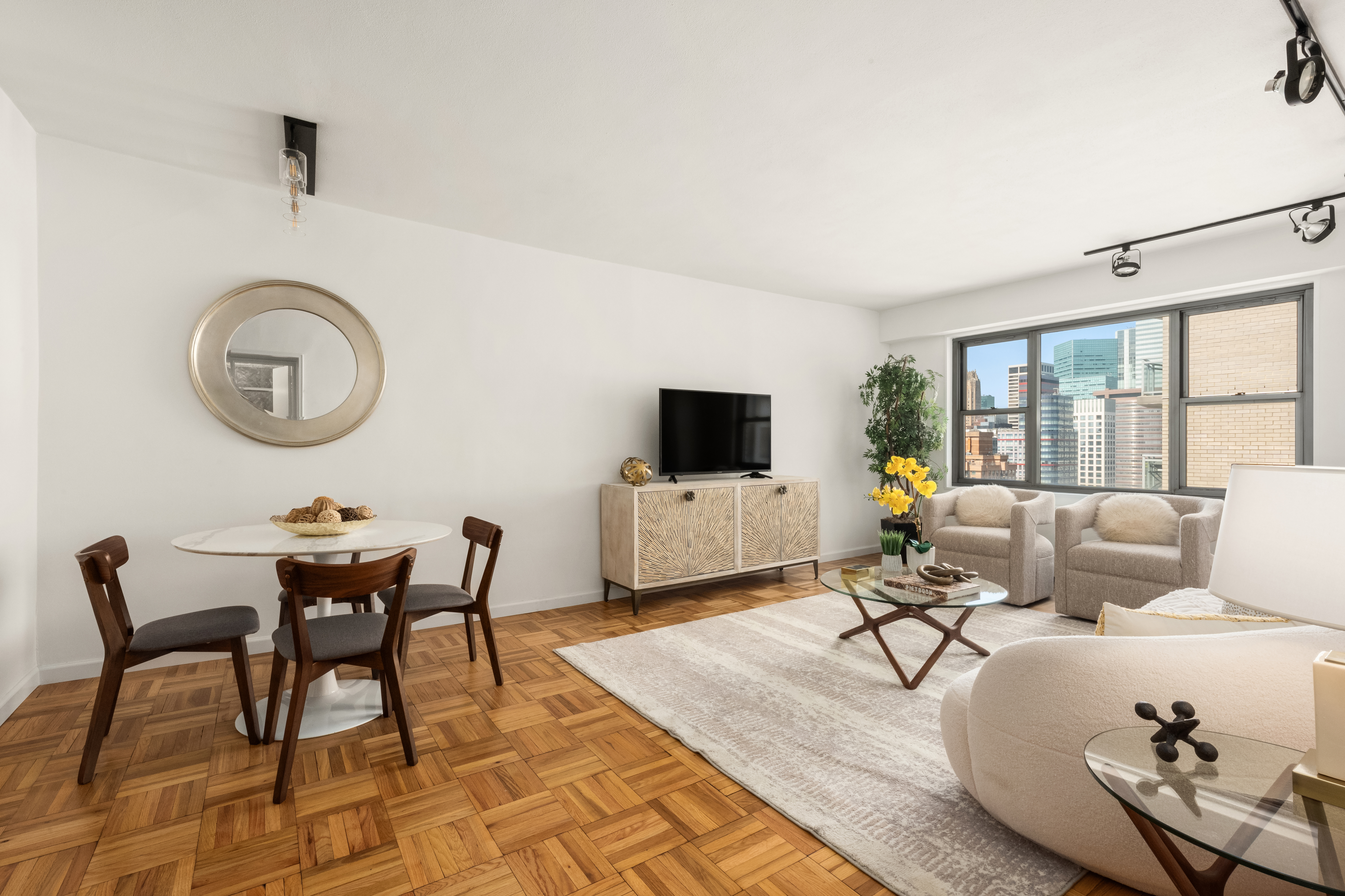 400 East 56th Street, Unit 38S Manhattan, NY 10022 - Photo 1 of 16 a living room with furniture and a flat screen tv