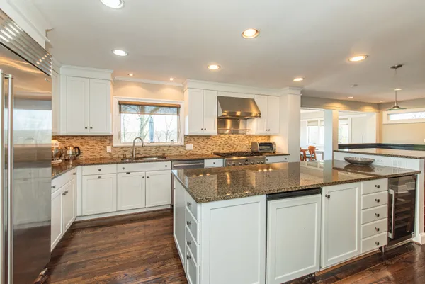 a kitchen with sink stove and cabinets