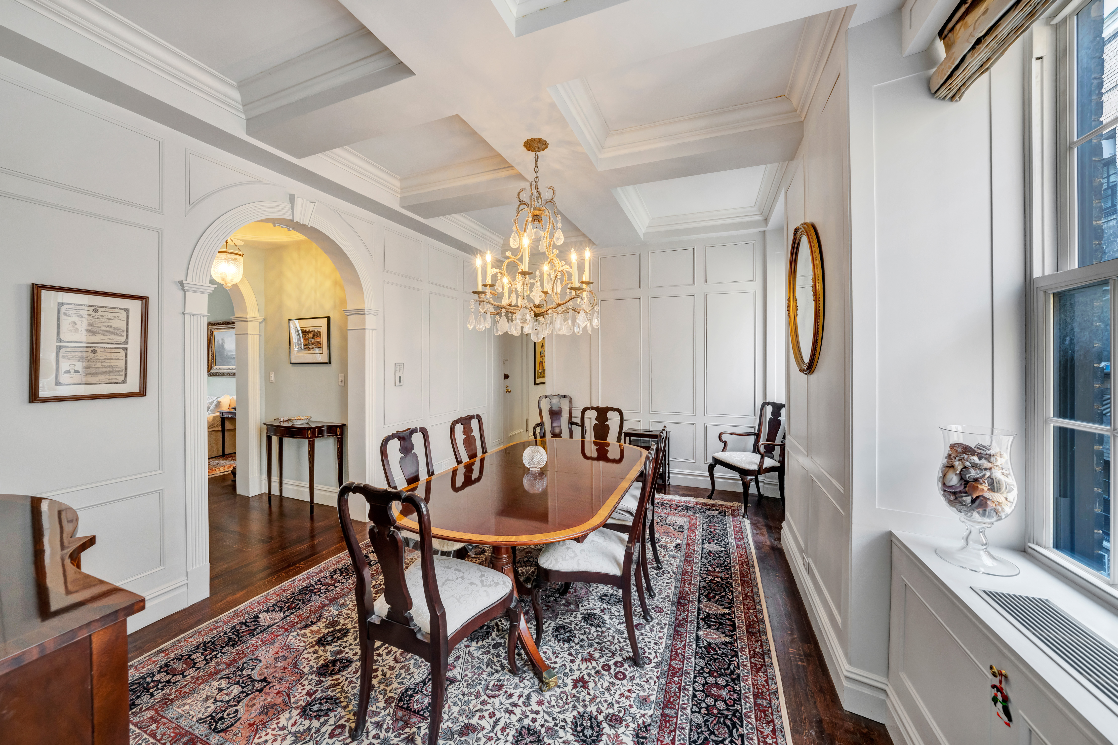 1060 Park Avenue, Unit 13G Manhattan, NY 10128 - Photo 3 of 11 a view of a dining room with furniture and chandelier