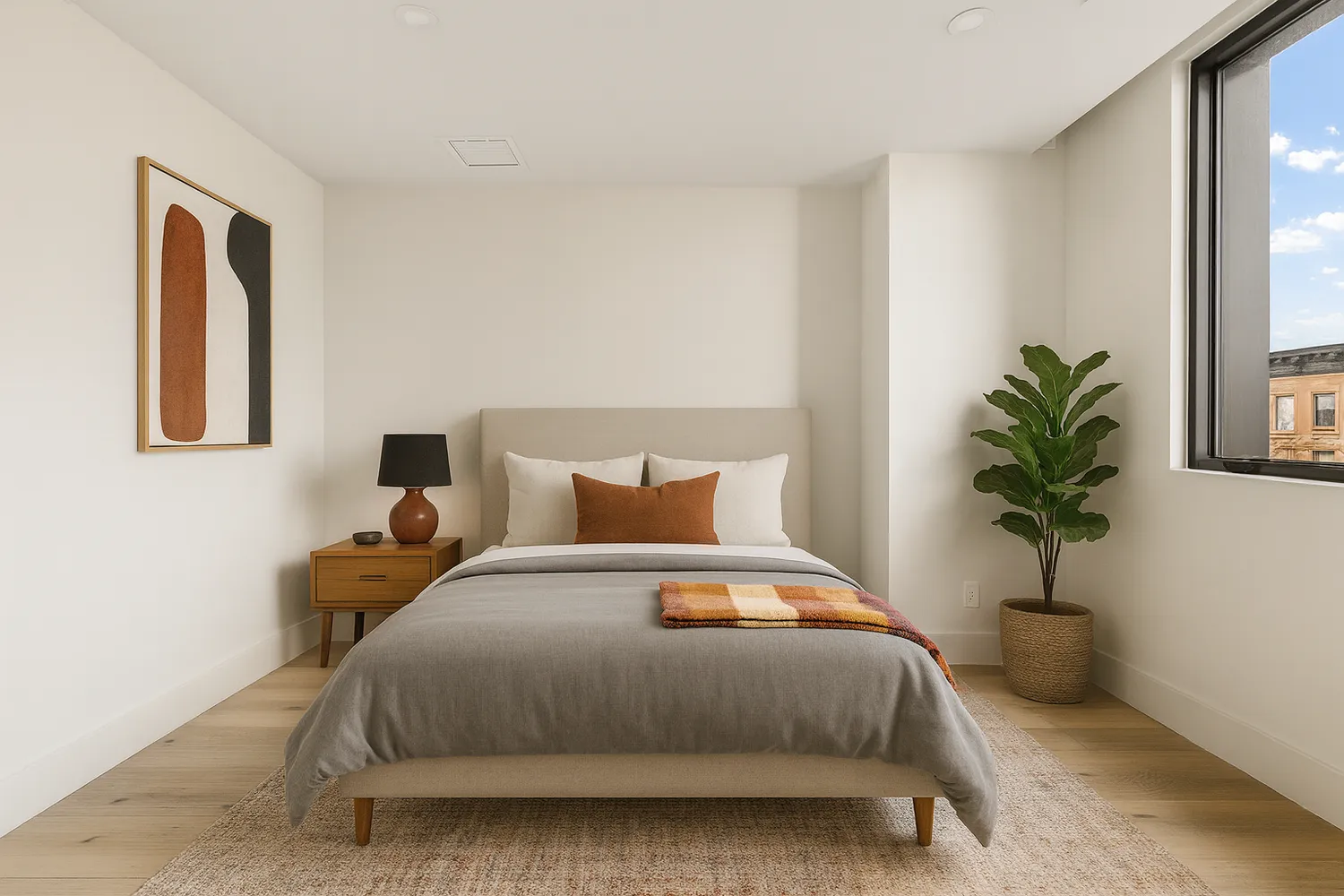 a bedroom with a bed lamp and a potted plant