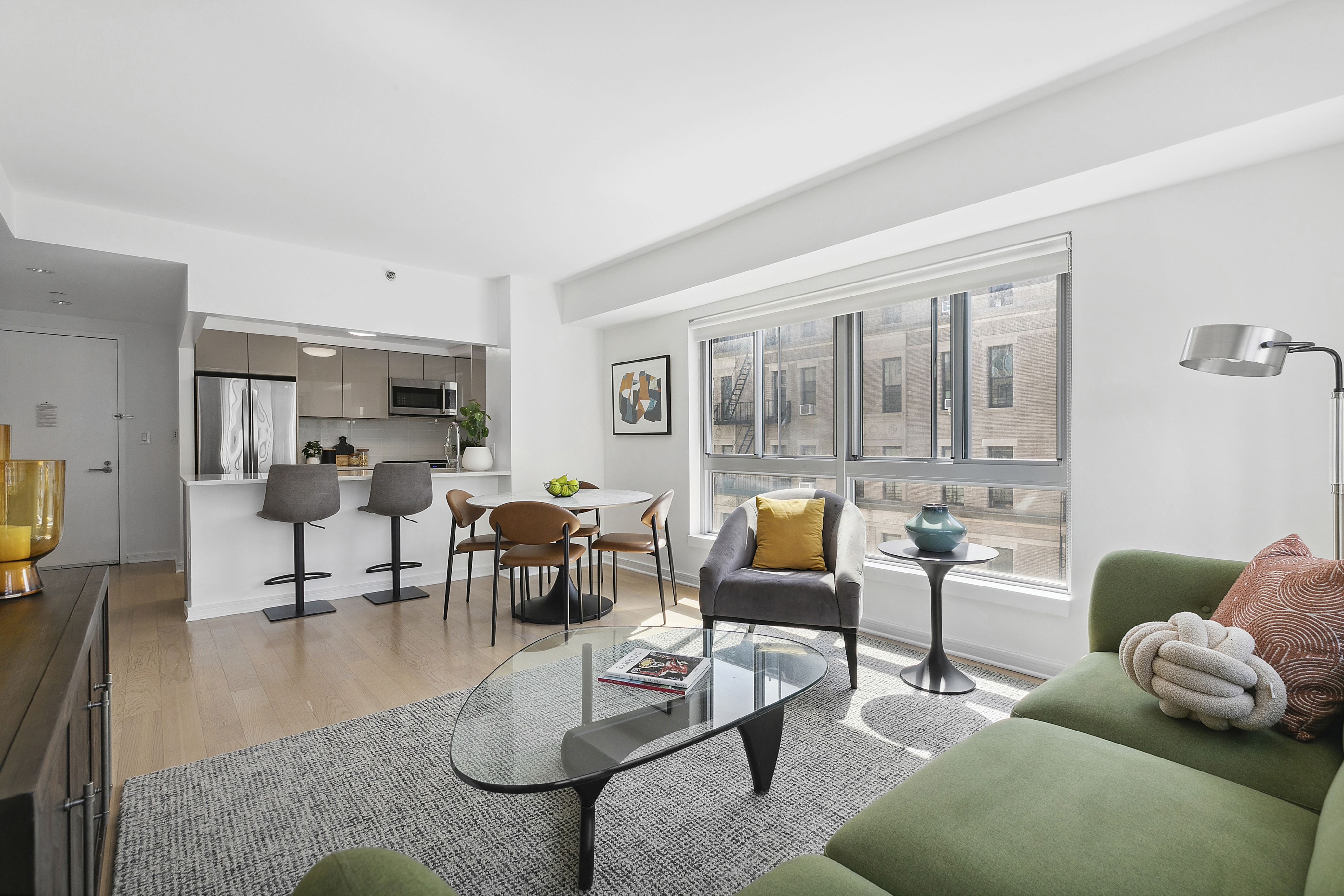 171 West 131st Street, Unit 407 Manhattan, NY 10027 - Photo 2 of 18 a living room with furniture and a large window