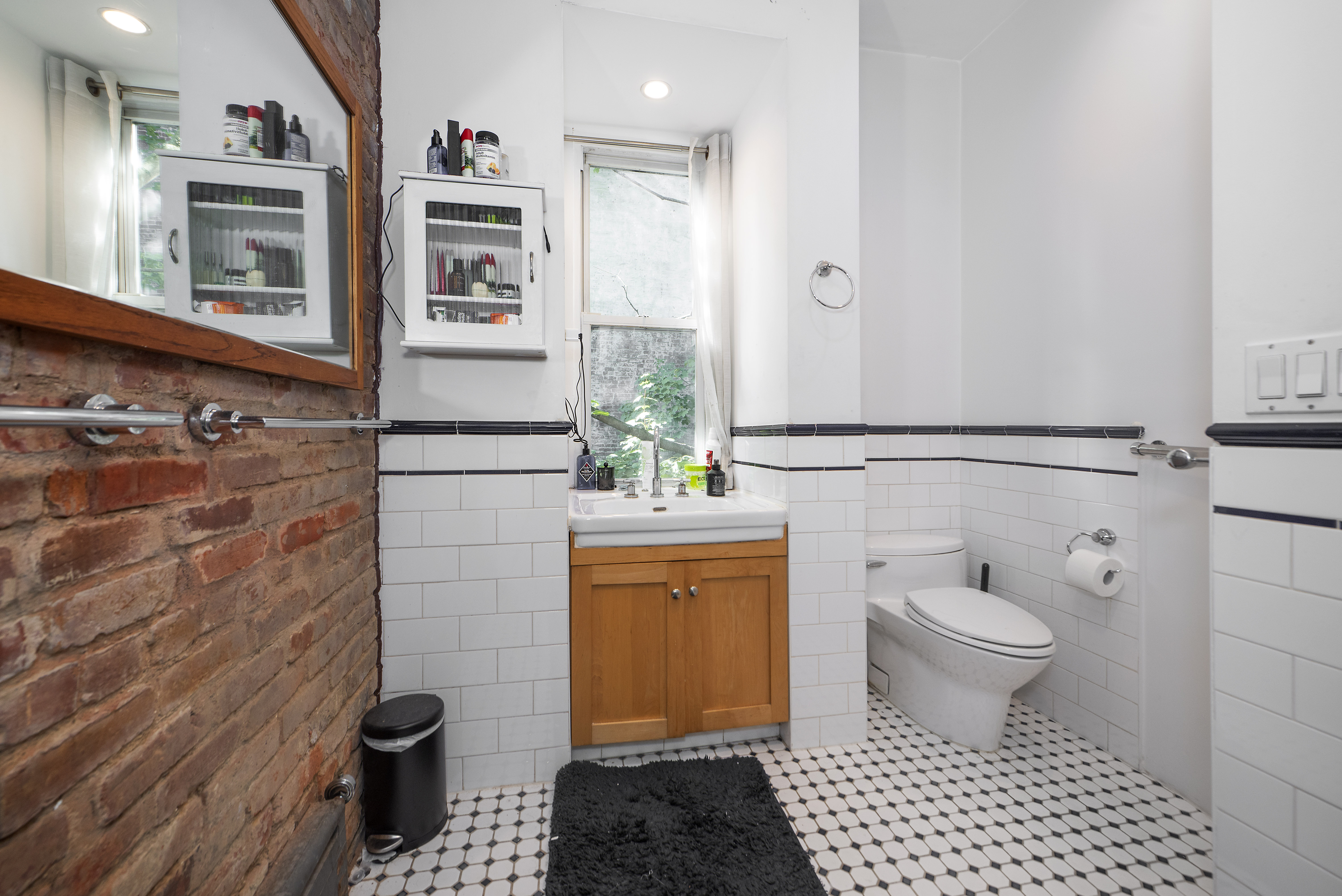249 East Houston Street, Unit 4 Manhattan, NY 10002 - Photo 6 of 10 a bathroom with a sink toilet and shower