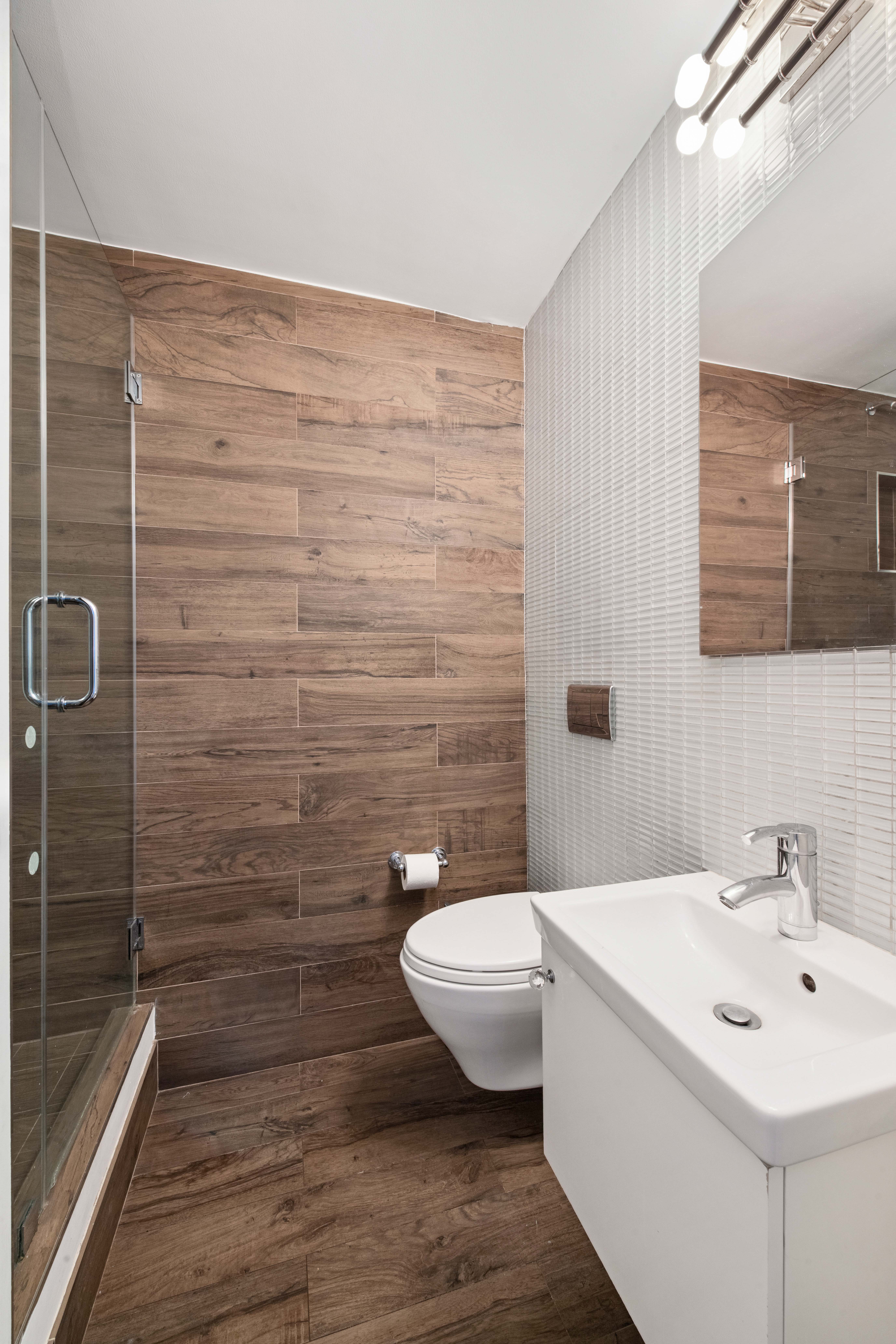 201 East 36th Street, Unit 17C Manhattan, NY 10016 - Photo 11 of 13 a bathroom with a sink a toilet and shower