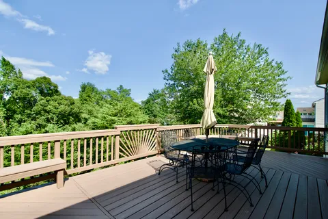 a view of a deck with table and chairs and wooden floor