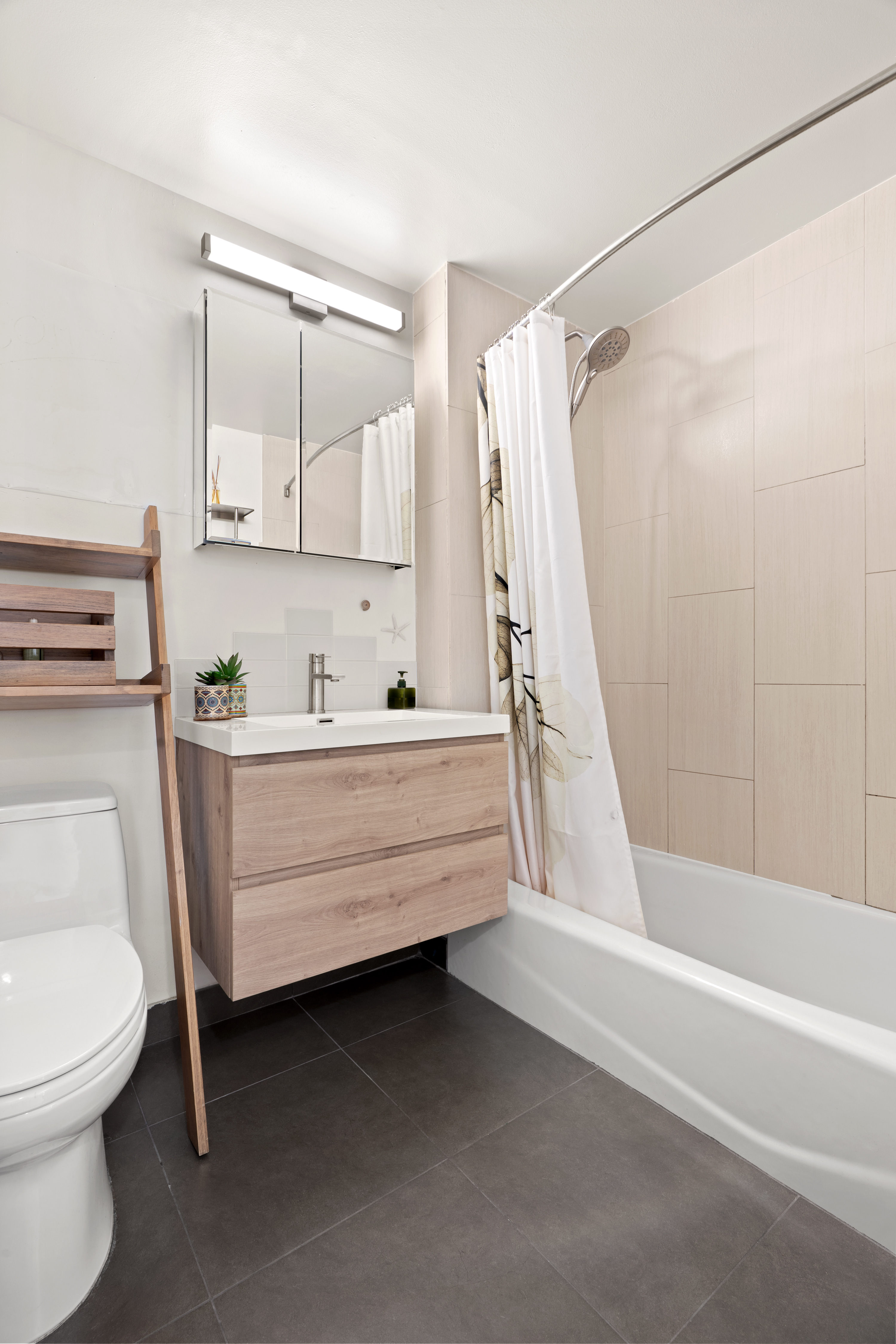 1810 3rd Avenue, Unit 9D Manhattan, NY 10029 - Photo 5 of 10 a bathroom with a sink a mirror and a toilet