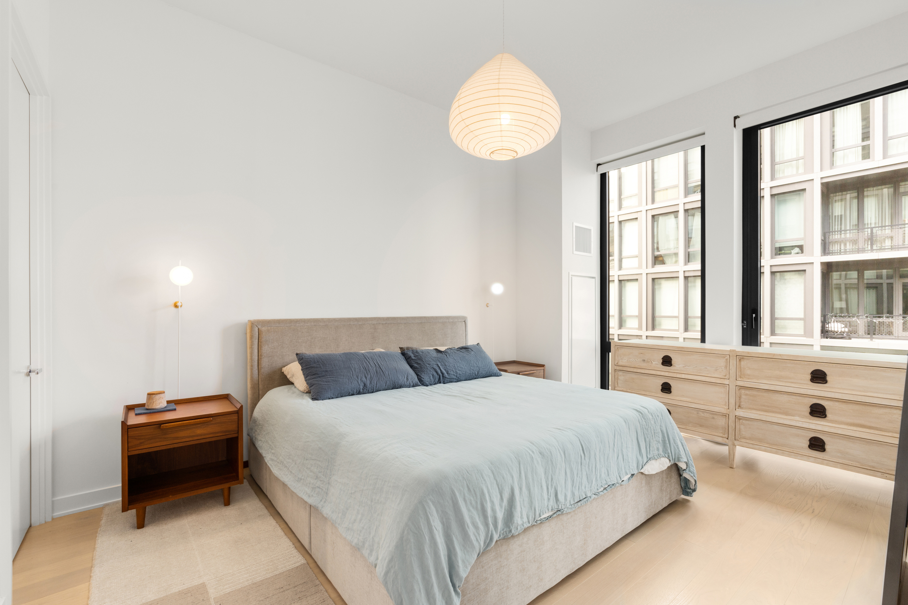 77 Charlton Street, Unit S10A Manhattan, NY 10014 - Photo 5 of 27 a bedroom with a bed and a chandelier