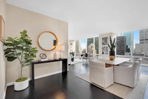 a living room with fireplace furniture and a large window