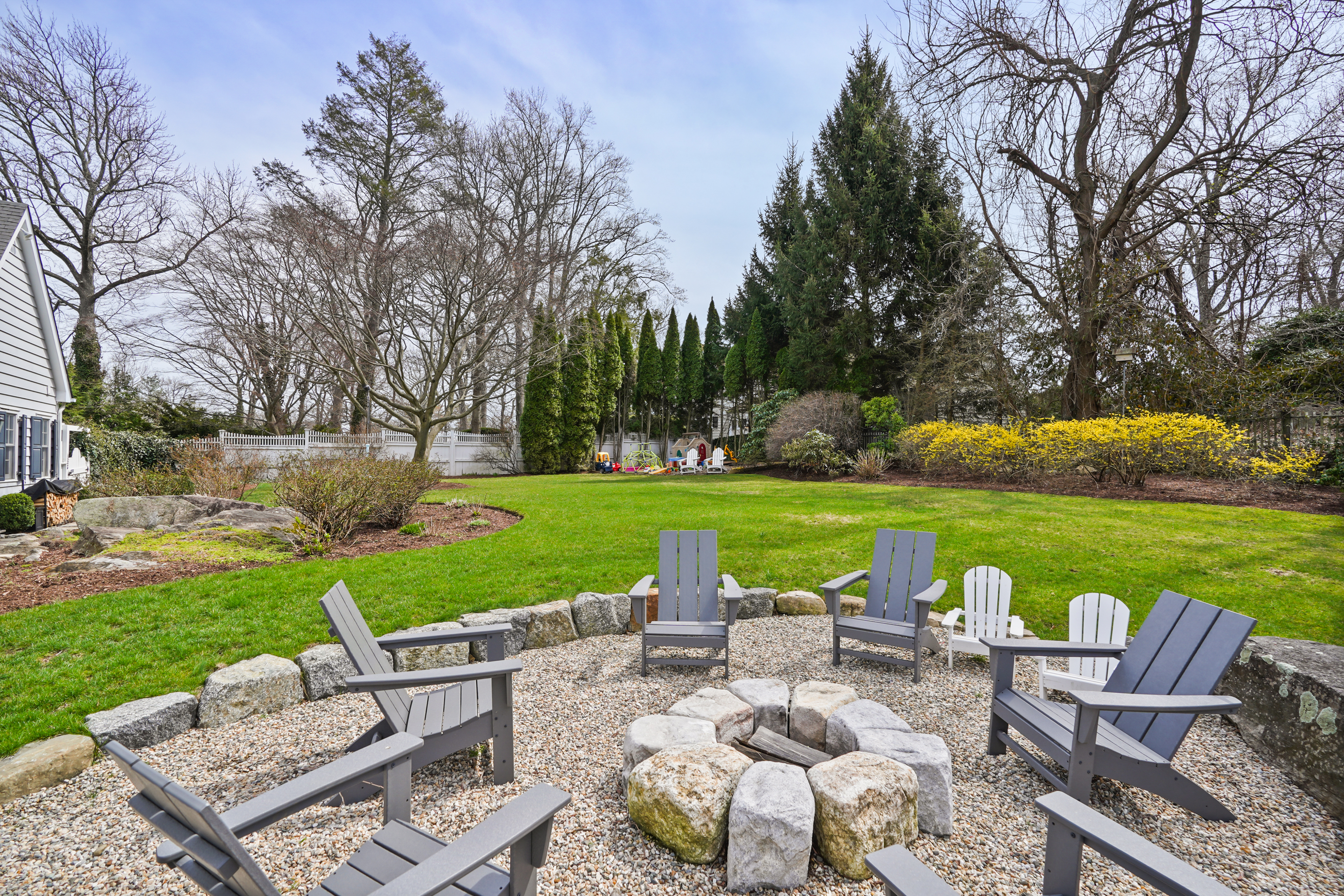 15 Anderson Road Greenwich, CT 06830 - Photo 24 of 30 a view of a patio with couches potted plants and a big yard